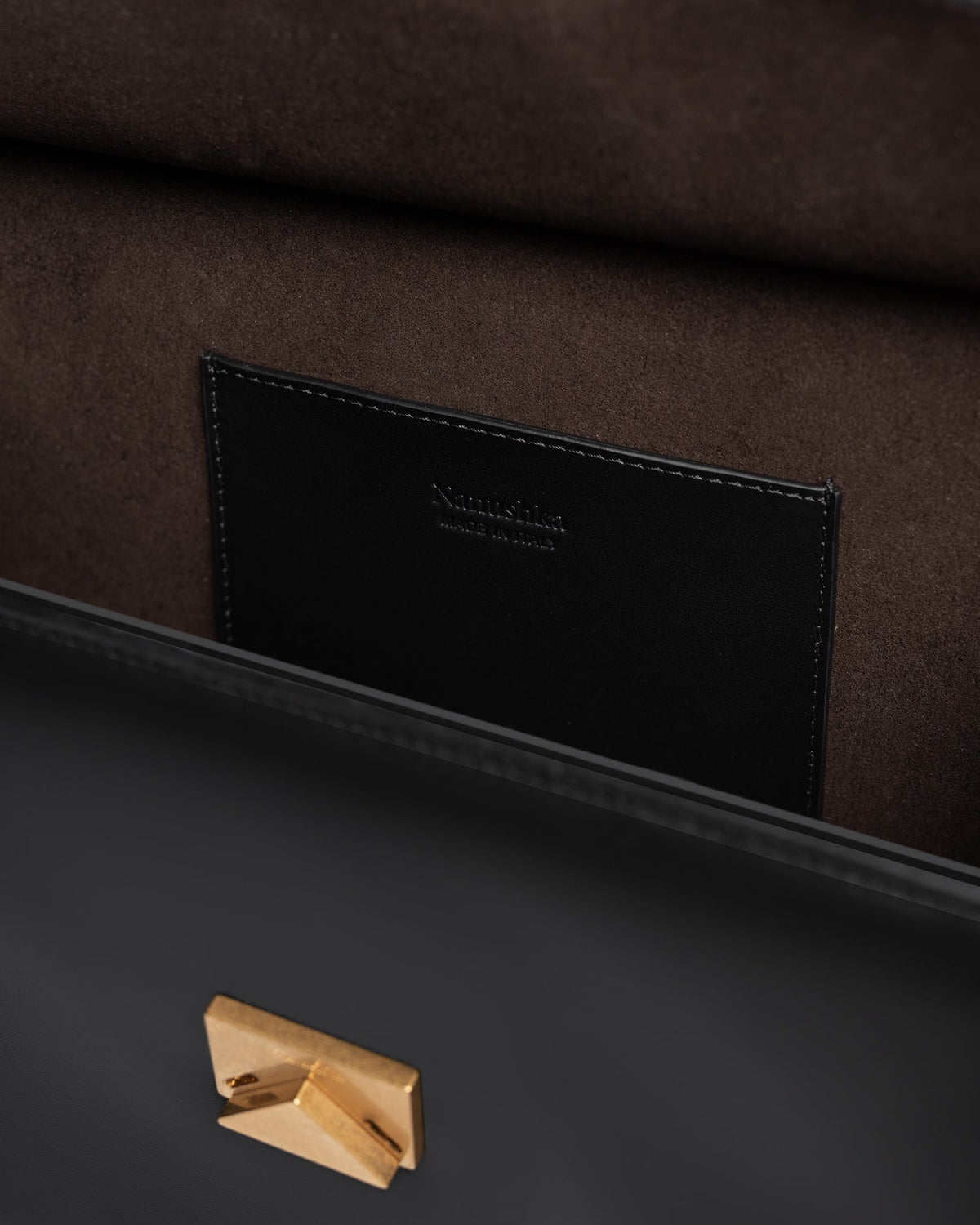The SANDI Lock Top handle bag - Black | Nanushka